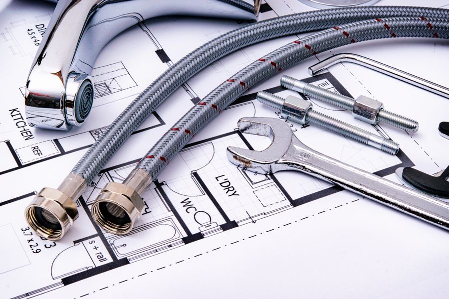 Tools beside plumbing parts for fixture installation